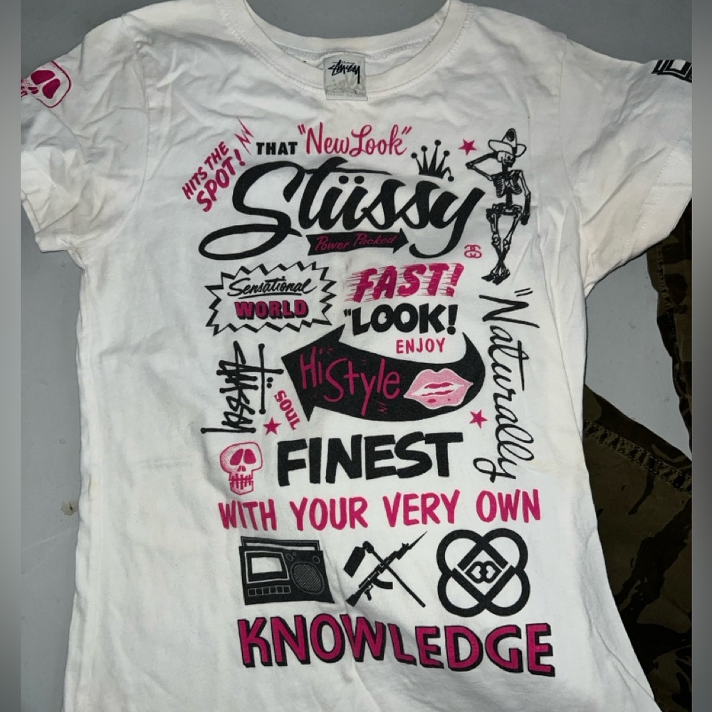 White Stussy graphic tee with bold graphics